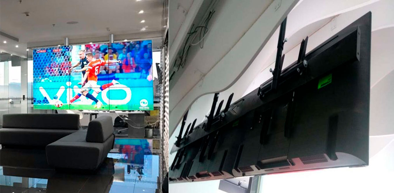 Videowall de 2 pantallas curvas verticales por 4 horizontales ancladas a la pared Videowall de 2 pantallas curvas verticales por 4 horizontales ancladas a la pared